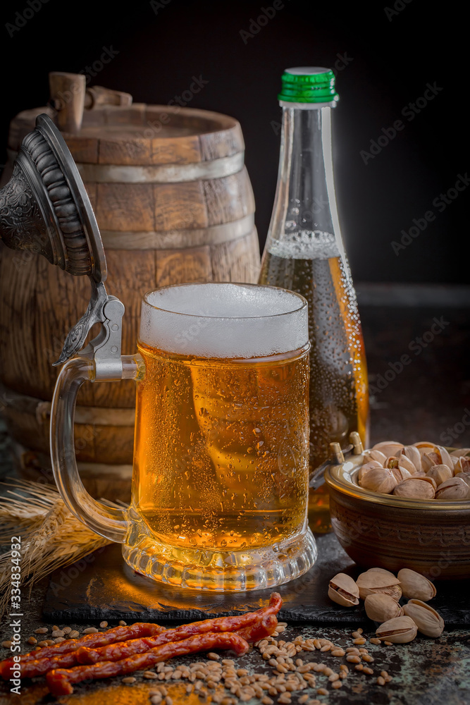 Light beer in a glass, on an old background. Light beer in a glass, on an old background.