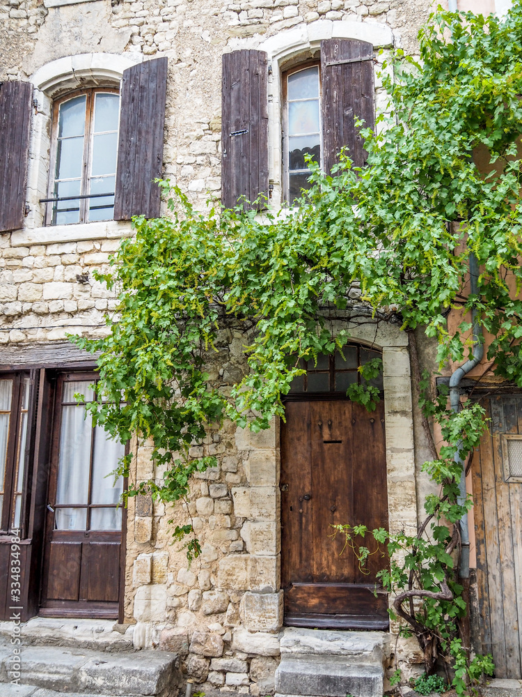 Medieval windows arches and doors in Provence, surrounded by greenery. Medieval windows arches and doors in Provence, surrounded by greenery.