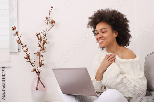 Communication and Connection during Coronavirus Lockdown , Self-isolation. Woman using online technology to keep in touch with Friends and Family. Good news and Gratitude concept photo