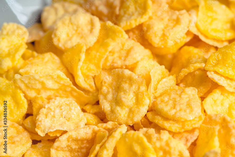 Tasty crispy corn flakes in bowl on the rustic background. Selective focus. Shallow depth of field. Tasty crispy corn flakes in bowl on the rustic background. Selective focus. Shallow depth of field.