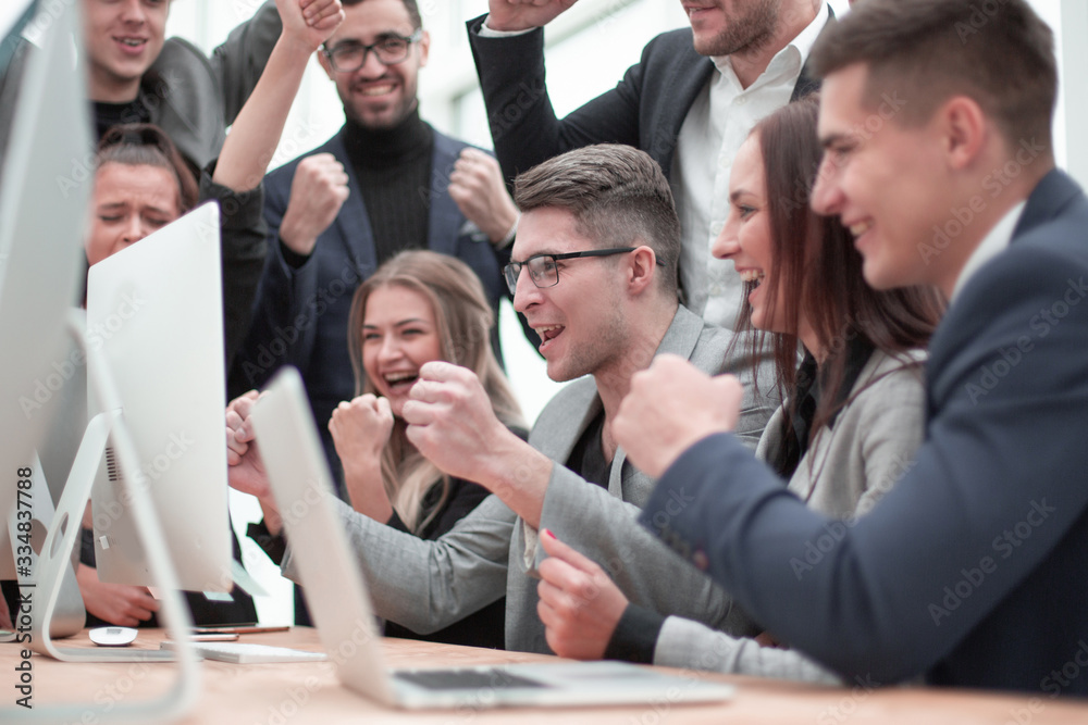 jubilant business team looking at the computer monitor jubilant business team looking at the computer monitor