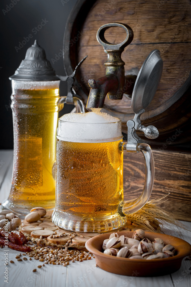 Light beer in a glass, on an old background. Light beer in a glass, on an old background.