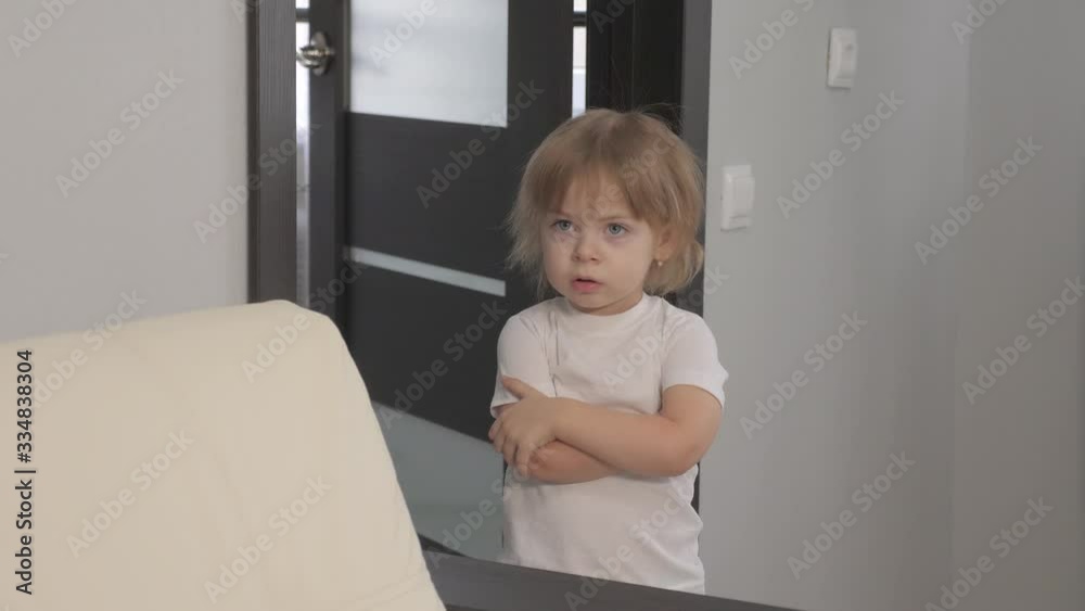little a girl offended hugs herself with her hands. blonde girl lifestyle indoors angry little a girl offended hugs herself with her hands. blonde girl lifestyle indoors angry