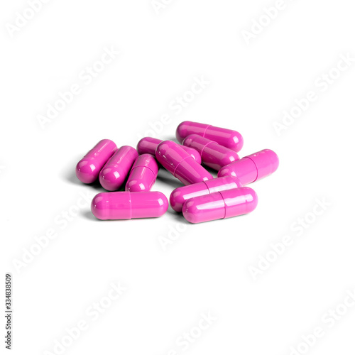 A bunch of pink pills isolated on a white background