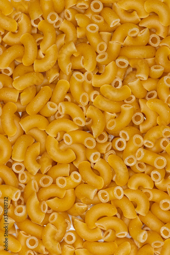 Flat lay of layer of macaroni on white porcelain plate