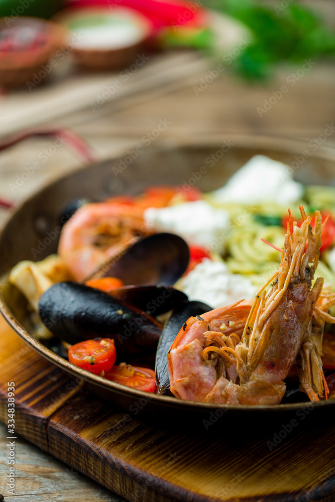 Pasta with seafood on old wooden table Pasta with seafood on old wooden table