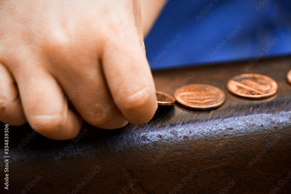 Fototapeta premium kid putting pennies on a railroad track