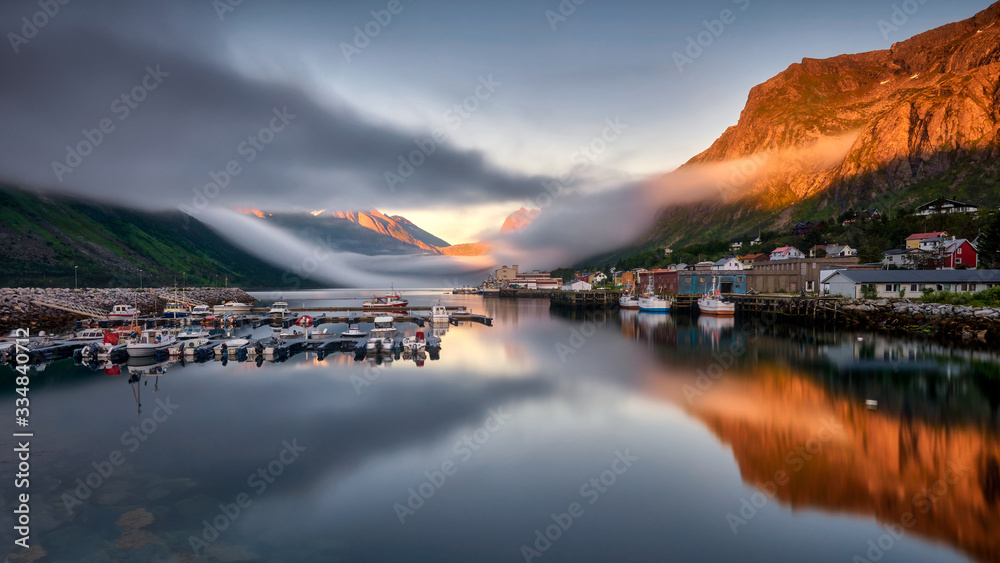 Norway, the island of Senja, a quiet fjord bay with a small marina Norway, the island of Senja, a quiet fjord bay with a small marina