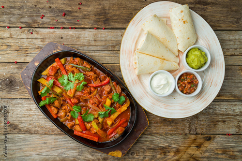 Fajitas with beef on wooden table