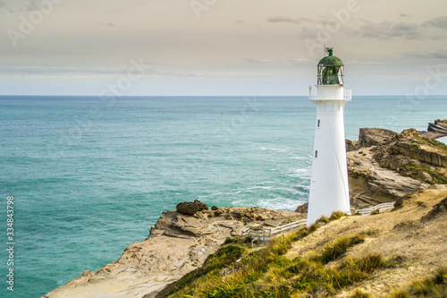 Panoramic scenic landscape view of the Castlepoint lighthouse in sunrise colours  white landmark  tourist popular attraction destination in North Island  New Zealand. 