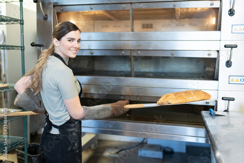 Young woman baking some bread