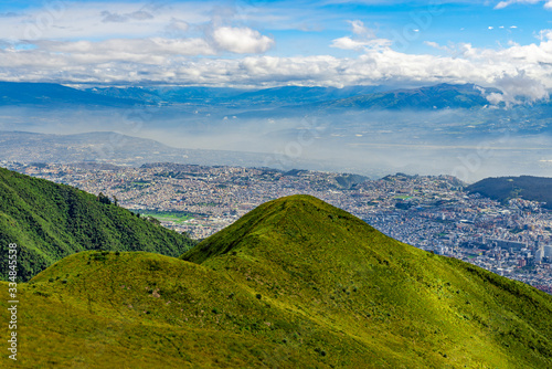 Aerial view from the cityscape of Quito city skyscrapers seen from the Pichincha Volcano, Ecuador.