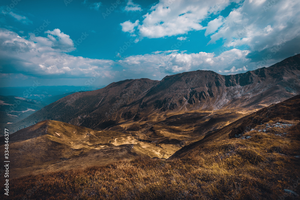 Obraz premium Hiking trough epic mountain landscape with a big backpack, exploring and feeling the freedom of nature