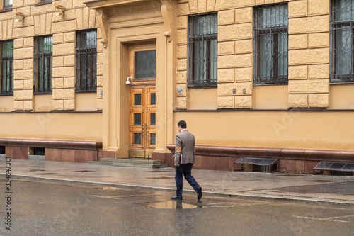  businessman rides in the rain without a coat