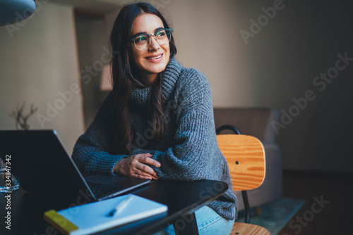 Young female entrepreneur in trendy eyeglasses sitting at modern office using laptop computer working on new Sustainable development project, Businesswoman working from home office