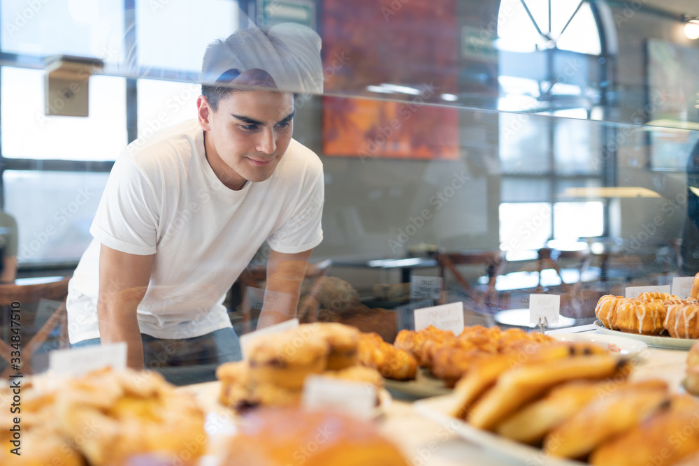 Man choosing some patries in a shop