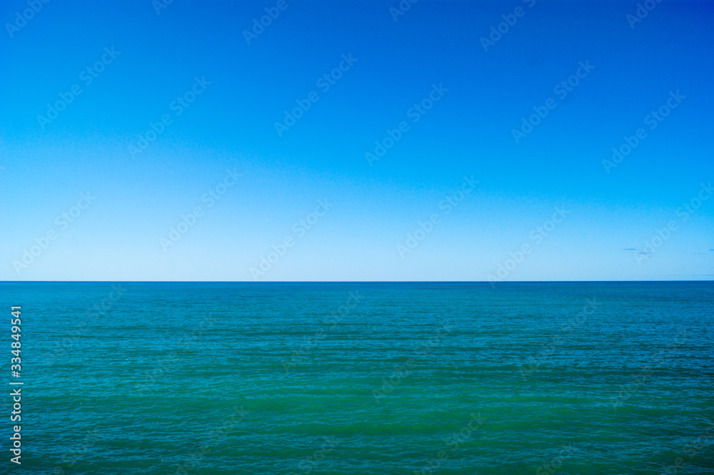 Calm sea and blue sky, horizontal photo.