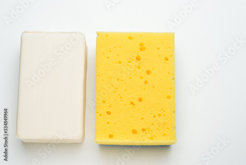 white soap yellow sponge isolated on a white background