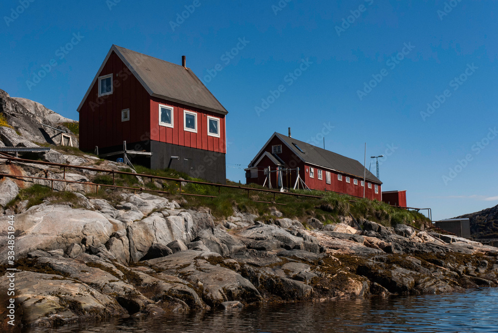 Colorful houses of the fishing town in Greenland. Mountains in the background. Colorful houses of the fishing town in Greenland. Mountains in the background.
