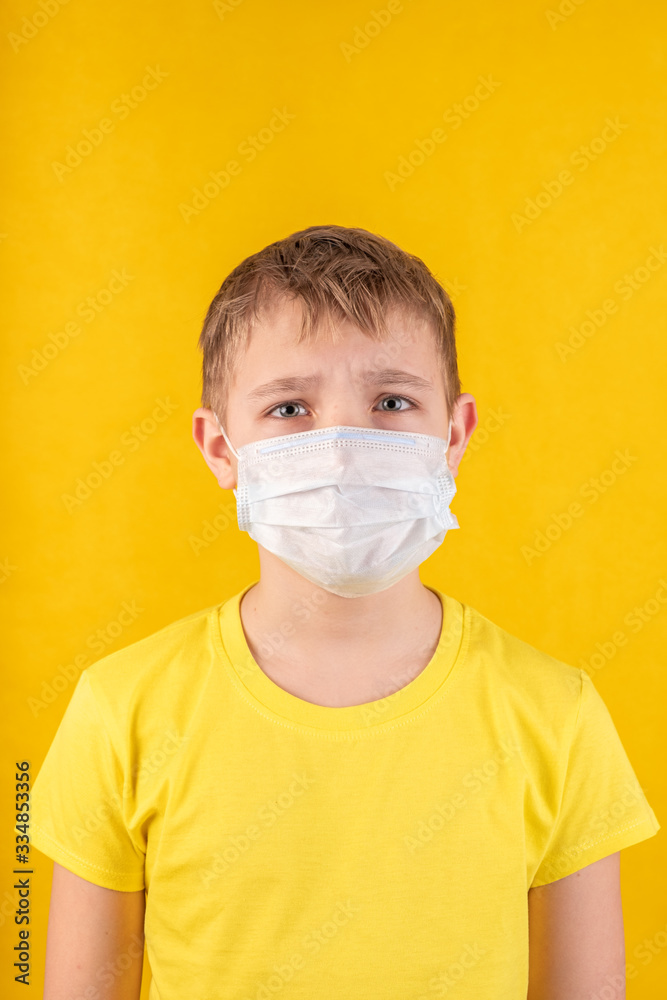preteen handsome boy in protective mask on a yellow background preteen handsome boy in protective mask on a yellow background