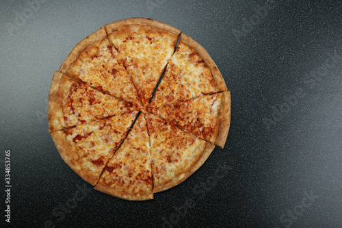 cheese pizza on black background top view