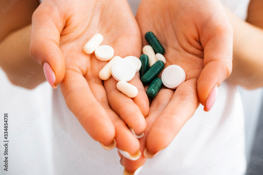 Pills in the hands closeup. Antibiotics. Antidepressants. Vitamin tablets. Antiviral. The