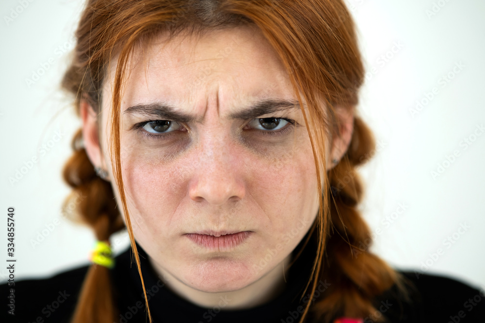 Close up portrait of angry redhead teenage girl. Close up portrait of angry redhead teenage girl.