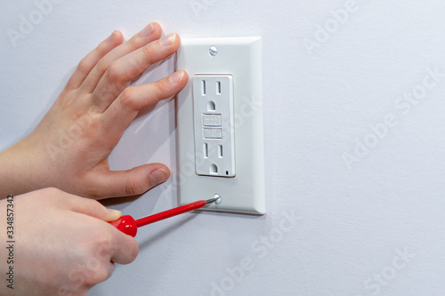 Fastening the finishing decorative platband for the electrical outlet