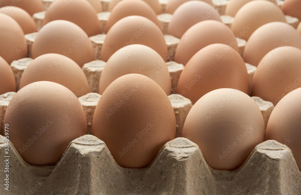 whole round raw brown homemade chicken eggs in a paper tray whole round raw brown homemade chicken eggs in a paper tray