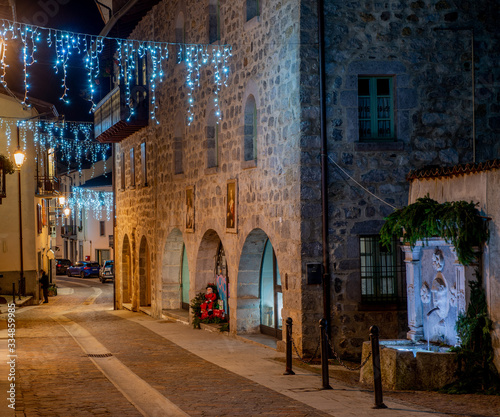 Street of the ancient village of illuminated for the Christmas holidays