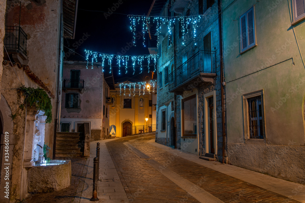 Street of the ancient village of illuminated for the Christmas holidays