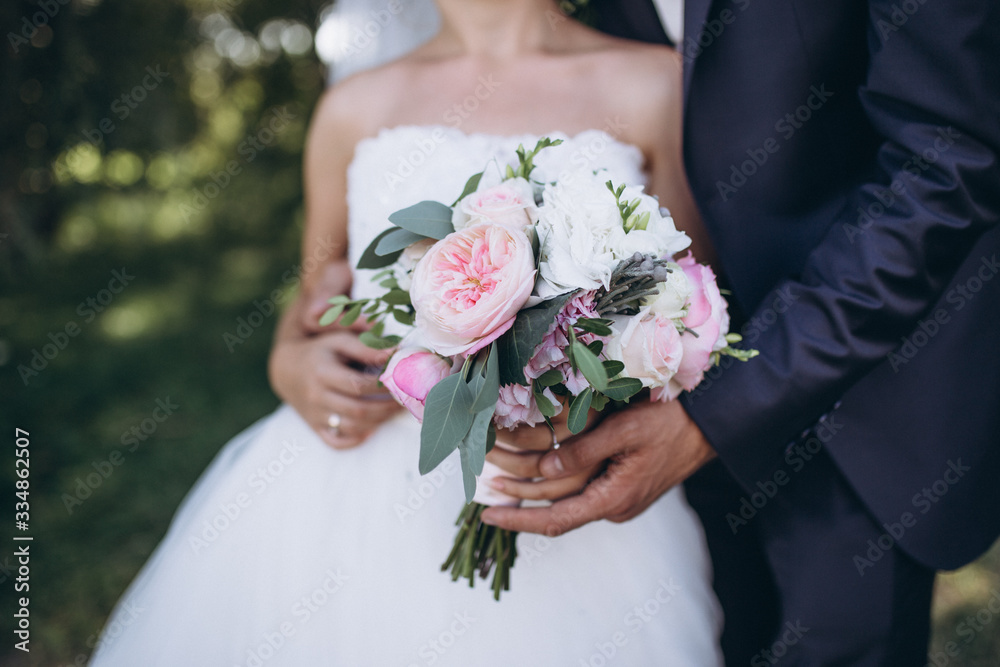 Beautiful wedding bouquet in bride's hand .