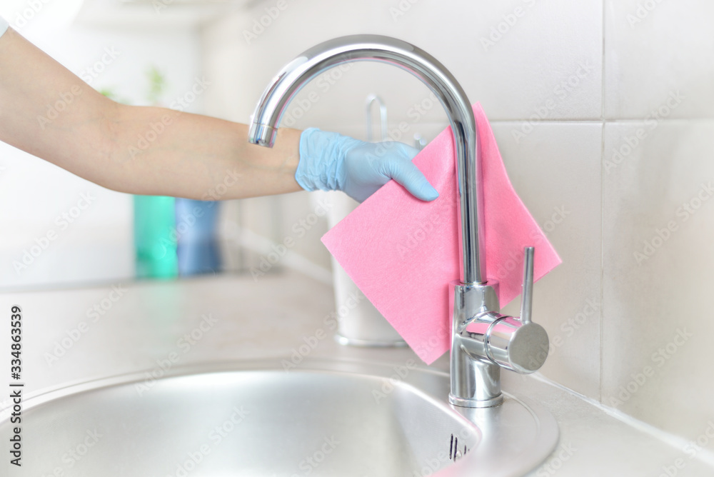 Woman in gloves cleaning kitchen. - obrazy, fototapety, plakaty 