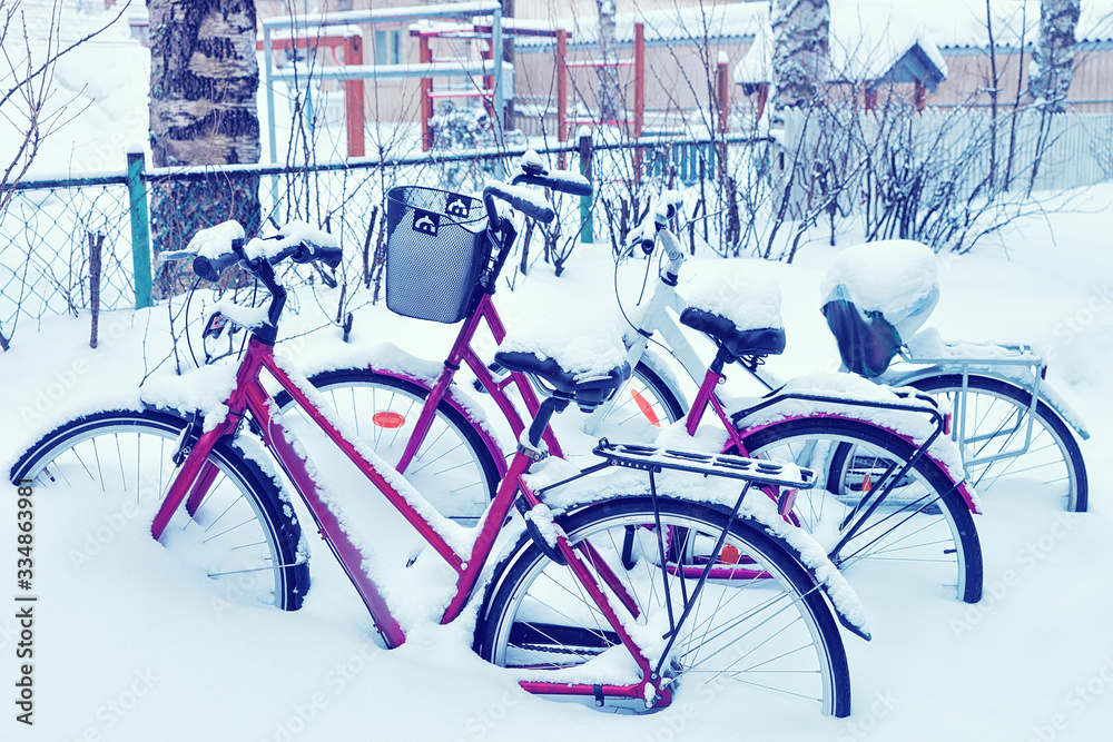 Bicycles covered by snow and parked in street winter Rovaniemi