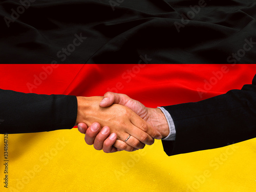 Business handshake on Germany flag background 