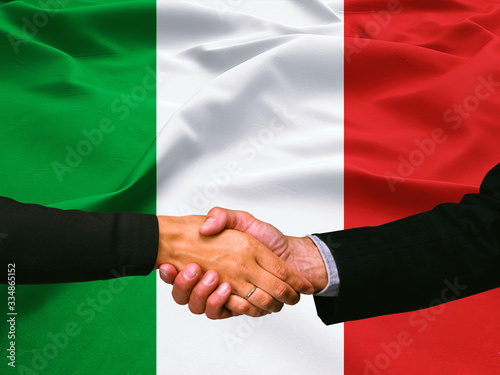 Business handshake on Italy flag background 