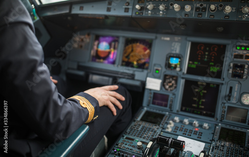 Pilot's hand accelerating on the throttle in a commercial airliner airplane flight cockpit during takeoff
