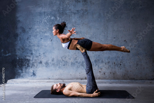 Latin couple practice acroyoga together. Concept of trust and support. 