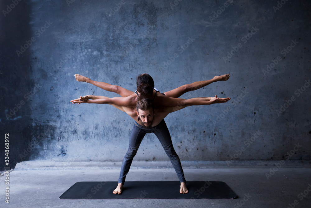 Latin couple practice acroyoga together. Concept of trust and support. 