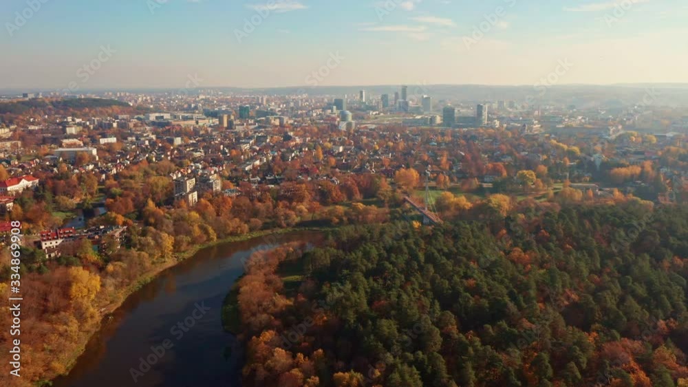 Aerial autumn view of the river and the city center. The river Neris runs through the city Vilnius, capital of Lithuania. Flying back and zooming in. Aerial autumn view of the river and the city center. The river Neris runs through the city Vilnius, capital of Lithuania. Flying back and zooming in.