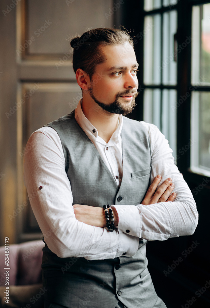 Portrait of a handsome groom in a stylish suit