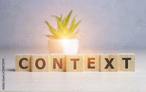 CONTEXT Word Written In Wooden Cube on table. photo