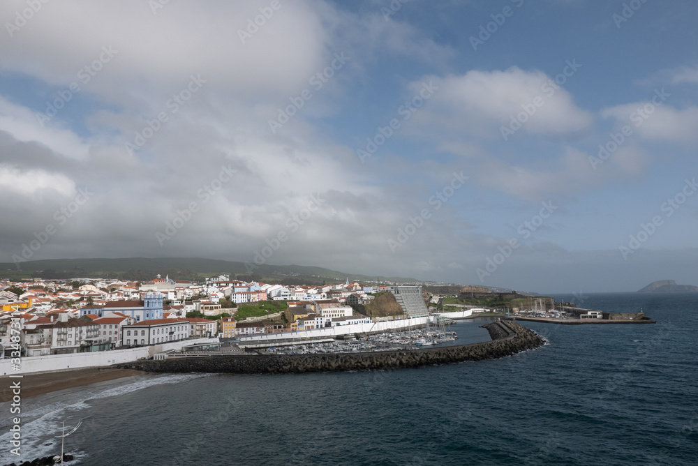 Scenic view of Terceira Island with water and marina at dusk