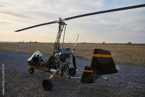 Single ultralight homemade gyroplane stands at the airdrome.