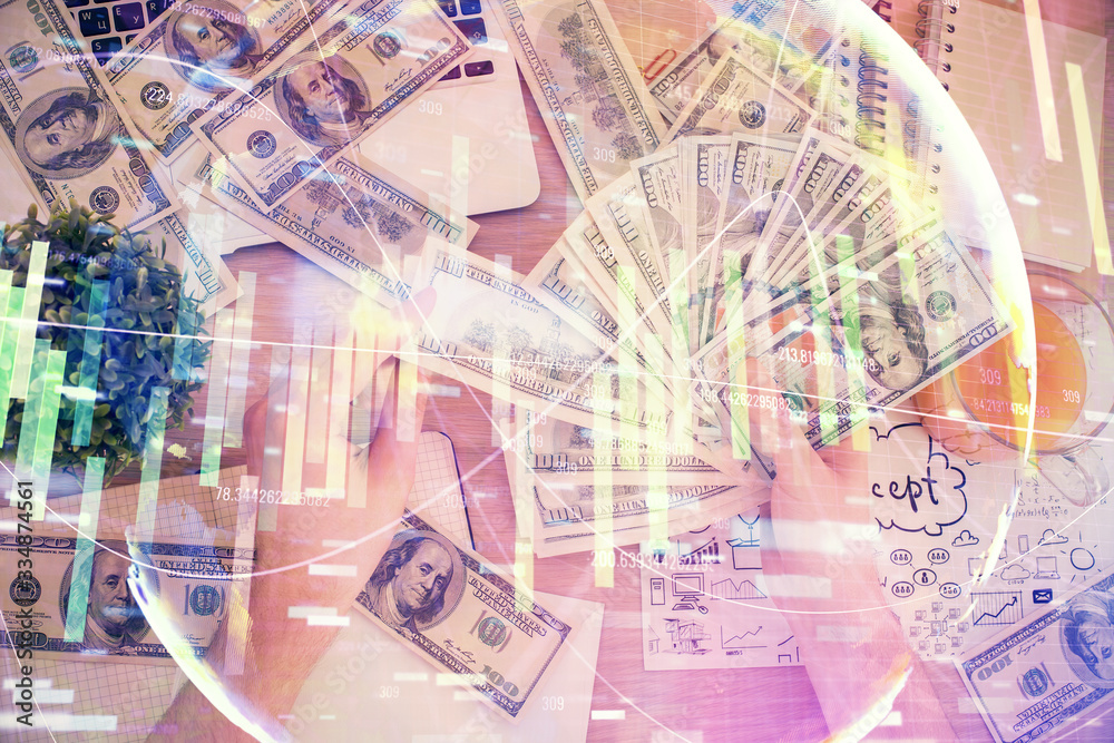 Multi exposure of financial theme drawing hologram and USA dollars bills and man hands. Business concept. Multi exposure of financial theme drawing hologram and USA dollars bills and man hands. Business concept.