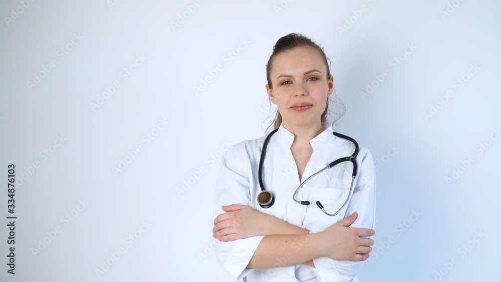 Portrait of a young woman doctor in a white coat with a stethoscope on a white background in a hospital Portrait of a young woman doctor in a white coat with a stethoscope on a white background in a hospital