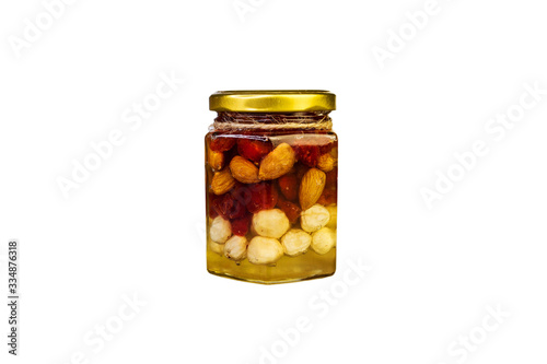 Mix of kernel And A Jar Of Golden Light Honey With A Honey Dipper