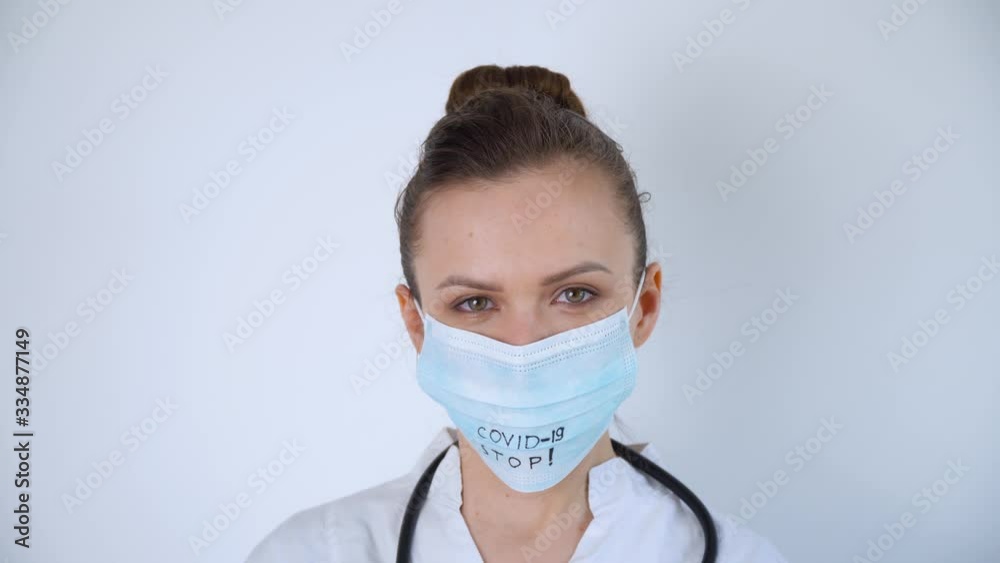 Close up of caucasian doctor with a stethoscope in protective mask. Covid-19 protection. Stop coronavirus