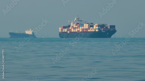 Long shot of container cargo ships in the sea of Hormuz strait in Persian Gulf Iran photo