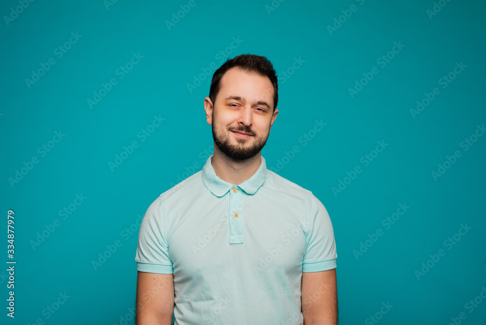 Happy millennial Caucasian guy isolated on blue studio background smiling with white healthy teeth, positive young man in casual clothes posing look at camera show good treatment result Happy millennial Caucasian guy isolated on blue studio background smiling with white healthy teeth, positive young man in casual clothes posing look at camera show good treatment result